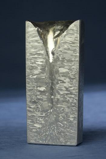 A polished surface showing a casting microstructure, revealing the crystalline grain structure